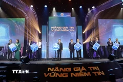 Nghi thức khai trương hệ thống công nghệ thông tin mới của thị trường chứng khoán Việt Nam. (Ảnh: Hứa Chung/TTXVN)