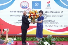 Đại diện Hãng Thông tấn Prensa Latina tại Việt Nam tặng hoa chúc mừng Thông tấn xã Việt Nam nhân Ngày Báo chí cách mạng Việt Nam. (Ảnh: Văn Điệp/TTXVN)