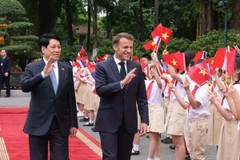 Chủ tịch nước Lương Cường và Tổng thống Pháp Emmanuel Macron với thiếu nhi Thủ đô Hà Nội. (Ảnh: Lâm Khánh/TTXVN)