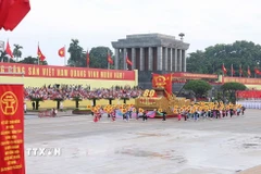 Xe mô hình Quốc huy nước Cộng hòa xã hội chủ nghĩa Việt Nam đi đầu khối diễu binh, diễu hành. (Ảnh: TTXVN)