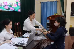 Các hộ dân nhận tiền thưởng. (Ảnh: Thái Hùng/TTXVN)