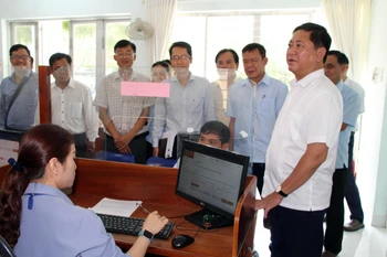 Ông Trần Quốc Nam (áo trắng), Chủ tịch Ủy ban Nhân dân tỉnh Ninh Thuận kiểm tra công tác chuẩn bị vận hành thử nghiệm của Trung tâm phục vụ hành chính công ở xã Ninh Phước. (Ảnh: Công Thử/TTXVN)