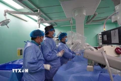 Các bác sỹ liên chuyên khoa tiến hành can thiệp cứu sống bệnh nhân. (Ảnh: TTXVN phát)