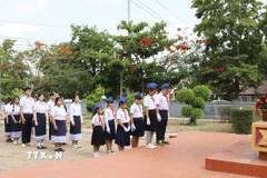 Học sinh trường Hữu nghị Lào-Việt Nam tỉnh Savannakhet dâng hoa tại Khu Di tích lịch sử Chủ tịch Hồ Chí Minh nhân kỷ niệm 135 năm Ngày sinh nhật Bác Hồ. (Ảnh: Xuân Tú/TTXVN) 