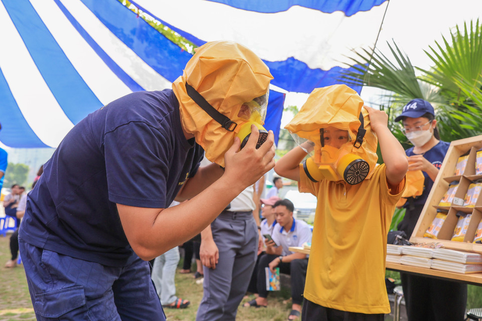 Các bạn nhỏ được hướng dẫn sử dụng mặt nạ chống khói đề phòng trường hợp có hỏa hoạn xảy ra. (Ảnh: Hoài Nam/Vietnam+)