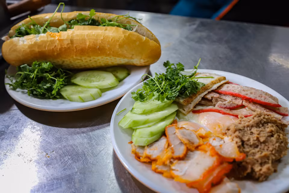 Không chỉ đẹp về hình thức, mùi vị của bánh mỳ kẹp Việt Nam mới là điểm hấp dẫn ấn tượng với thực khách. Đó là lớp vỏ bánh nóng giòn bên ngoài, sự đậm đà của lớp thịt bên trong và vị chua độc đáo của những loại rau quả tươi hoặc đã được trộn theo kiểu salad. (Ảnh: Hoài Nam/Vietnam+)