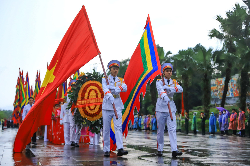 Trong không khí trang nghiêm, đoàn dâng hương gồm các khối nghi thức, đội rước kiệu, lễ vật khởi hành từ sân Trung tâm Lễ hội đền Hùng qua Nghi môn, đền Hạ, đền Trung lên đền Thượng. Đi đầu là đội tiêu binh rước cờ Tổ quốc, cờ hội đền Hùng và vòng hoa mang dòng chữ ‘Ðời đời nhớ ơn các Vua Hùng đã có công dựng nước.’ (Ảnh: Hoài Nam/Vietnam+)
