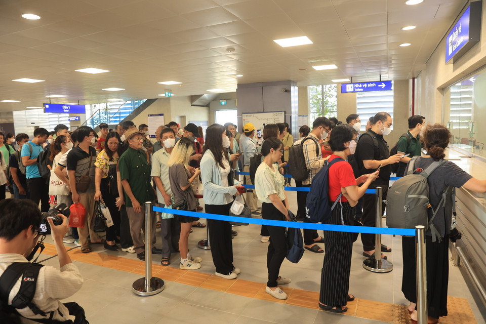 Hàng dài người dân xếp hàng, chờ đợi được là một trong những hành khách đầu tiên trải nghiệm chuyến tàu. (Ảnh: Hoài Nam/Vietnam+)