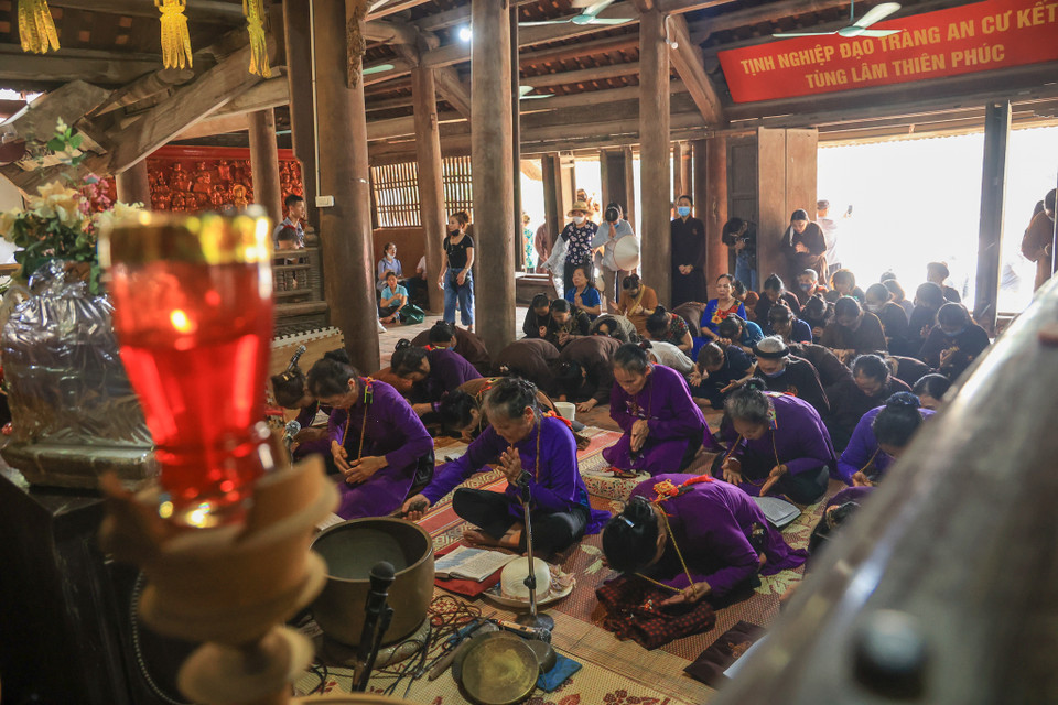 Nghi lễ bắt đầu bằng bài đọc kinh trong làng hương khói nghi ngút. Sau khi đọc bài kinh xin phép thì nhà sư và các bô lão tiến hành tắm tượng thành. (Ảnh: Hoài Nam/Vietnam+)