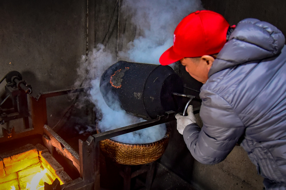 Càphê rang xong sẽ được kiểm tra chất lượng bằng cách cắn thử trực tiếp để kiểm tra độ chín, độ giòn của mẻ rang. (Ảnh: Hoài Nam/Vietnam+)