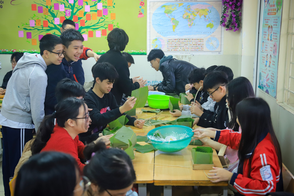Các em học sinh được trải nghiệm phong tục gói bánh chưng, đây là văn hóa người Việt thường dâng bánh chưng trong các lễ cúng ngày Tết để bày tỏ lòng thành, sự biết ơn đến đất trời vì một năm mưa thuận gió hòa vừa qua. (Ảnh: Hoài Nam/Vietnam+)