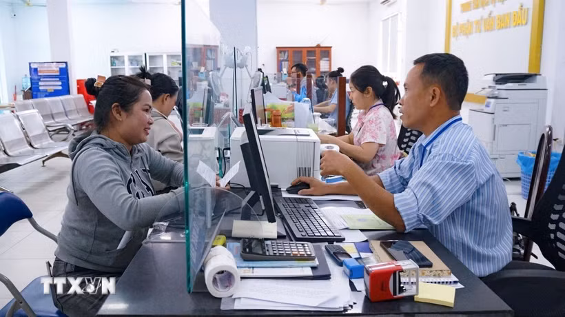 Cán bộ tại Trung tâm Phục vụ hành chính công phường Tân Ninh hướng dẫn người dân thực hiện thủ tục hành chính trên môi trường số. (Ảnh: Minh Phú/TTXVN)