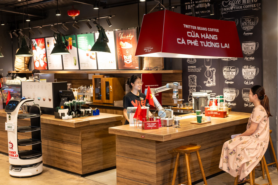 Trong không khí cả nước kỷ niệm 50 năm Ngày Giải phóng miền Nam, thống nhất đất nước, không khí ngày Quốc tế lao động, đổi mới sáng tạo tràn ngập khắp nơi, giữa lòng Hà Nội, một quán cafe ở phố Vũ Phạm Hàm (Cầu Giấy, Hà Nội) đã chọn dịp này giới thiệu trải nghiệm độc đáo: nhân viên robot pha chế, phục vụ, chụp ảnh và viết thư pháp ngay trong quán. Hình ảnh thân thiện của robot pha cafe và robot thư pháp ở quán như một minh chứng sống động cho sự giao thoa giữa truyền thống văn hóa và công nghệ tương lai. (Ảnh: Minh Sơn/Vietnam+)