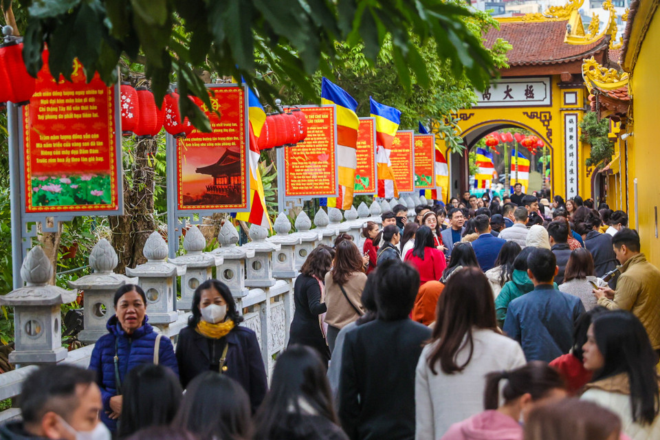 Tại chùa Trấn Quốc, một trong những ngôi chùa cổ kính và linh thiêng bậc nhất Thủ đô, hàng trăm người xếp hàng dài để vào lễ. (Ảnh: Minh Sơn/Vietnam+)