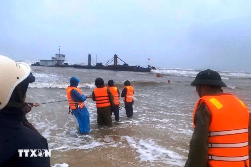 Các lực lượng tích cực ứng cứu, đưa các thuyền viên trên tàu gặp nạn vào bờ. (Ảnh: TTXVN phát)
