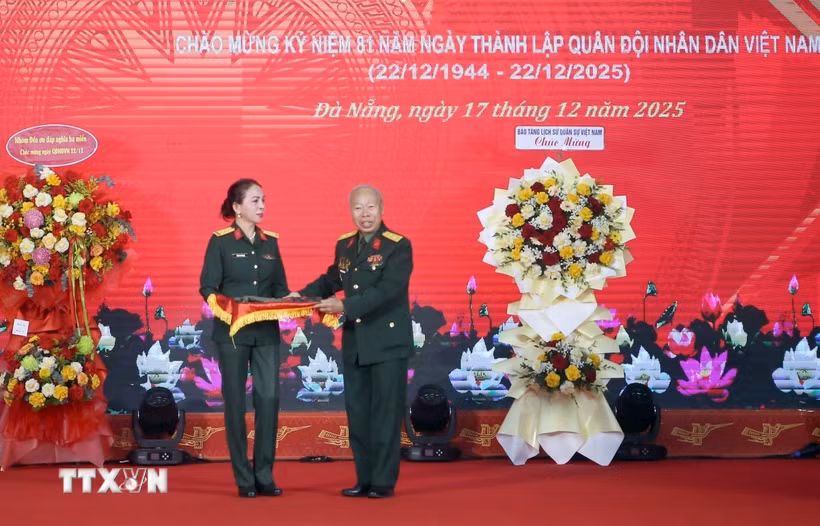 Thượng tá Trần Thị Anh Thư, Giám đốc Bảo tàng Quân khu 5 (trái) tiếp nhận các hiện vật được trao tặng tại buổi tổng kết. (Ảnh: Trần Lê Lâm/TTXVN)