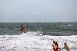 Sóng mạnh, gió lớn của biển Mũi Né (Lâm Đồng) luôn tạo được cảm giác mạnh, thích thú cho du khách chơi lướt ván diều. (Ảnh: Nguyễn Thanh/TTXVN)