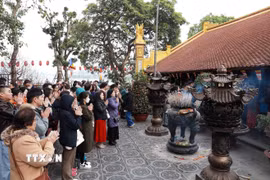 Ngưởi dân Hà Nội đi lễ đầu năm tại chùa Trấn Quốc sáng mùng 1 Tết Ất Tỵ. (Ảnh: Quốc Khánh/TTXVN)
