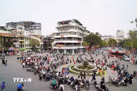 Người dân tụ tập chụp ảnh trước thời điểm phá dỡ tòa nhà "Hàm cá mập". (Ảnh: Khánh Hòa/TTXVN)