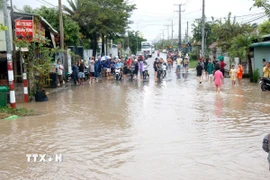 Nhiều tuyến đường trung tâm xã Hàm Thuận bị ngập sâu, các phương tiện không thể lưu thông. (Ảnh: Nguyễn Thanh/TTXVN)