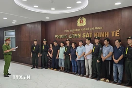 Cơ quan điều tra tống đạt quyết định khởi tố đối với các đối tượng. (Ảnh: TTXVN phát)