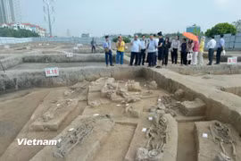 Các chuyên gia nghiên cứu và truyền thông tham quan các hố khai quật ở Vườn Chuối. (Ảnh: Phương Anh/Vietnam+)