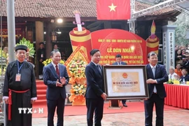 Phó Chủ tịch UBND tỉnh Bắc Ninh Phan Thế Tuấn trao Bằng xếp hạng Di tích quốc gia đặc biệt quần thể di tích đình, chùa, từ chỉ Thổ Hà cho phường Vân Hà. (Ảnh: Đồng Thúy/TTXVN)