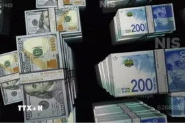 Đồng shekel (phải) của Israel và đồng đôla Mỹ. (Ảnh: Reuters/TTXVN)