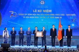 Thừa ủy quyền của Chủ tịch nước, Thứ trưởng Bộ Y tế Trần Văn Thuấn trao Huân chương Lao động hạng Ba cho Bệnh viện Phụ sản Trung ương. (Ảnh: Minh Quyết/TTXVN)