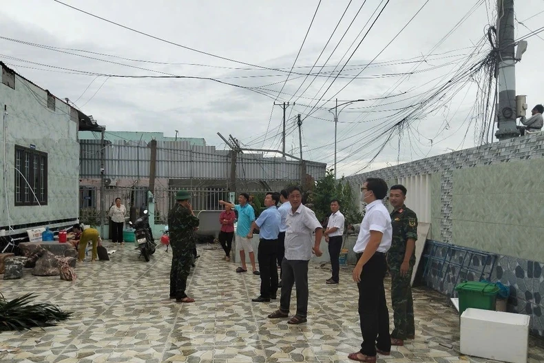 Lực lượng chức năng có mặt tại hiện trường hỗ trợ người dân có nhà bị ảnh hưởng khắc phục hậu quả, sớm ổn định cuộc sống. (Ảnh: TTXVN phát)