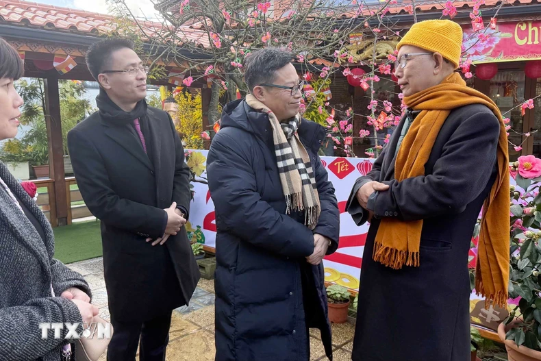 Đại sứ Việt Nam tại Pháp Trịnh Đức Hải (ngoài cùng bên phải) gửi lời chúc mừng năm mới tới Hòa thượng Thích Thịnh Quang, Trụ trì chùa Khuông Việt. (Ảnh: Hữu Chiến/TTXVN)