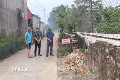 Ủy ban nhân dân xã Thanh Sơn (Ninh Bình) chỉ đạo khắc phục các vị trí bị ảnh hưởng, khoanh vùng, cắm biển cảnh báo và thông tin đến người dân. (Ảnh: Thùy Dung/TTXVN)