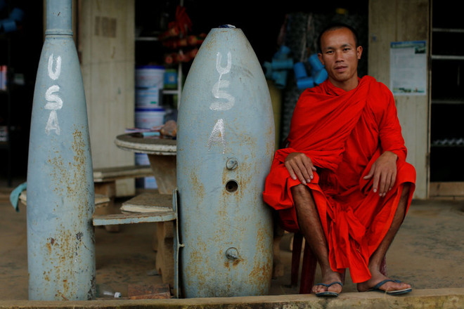 Một thầy tu đang ngồi bên quả bom do không quân Mỹ thả xuống trong chiến tranh Việt Nam ở Xieng Khouang (Lào). (Nguồn: Sputniknews) Toàn cảnh những sự kiện nổi bật diễn ra trong tuần qua ảnh 10