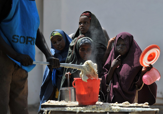 Ảnh tư liệu: Trẻ em Somalia chờ nhận thực phẩm cứu trợ tại khu vực ngoại ô Mogadishu. (Nguồn: AFP/TTXVN) LHQ cảnh báo về khủng hoảng nhân đạo do hạn hán ở Somalia ảnh 1