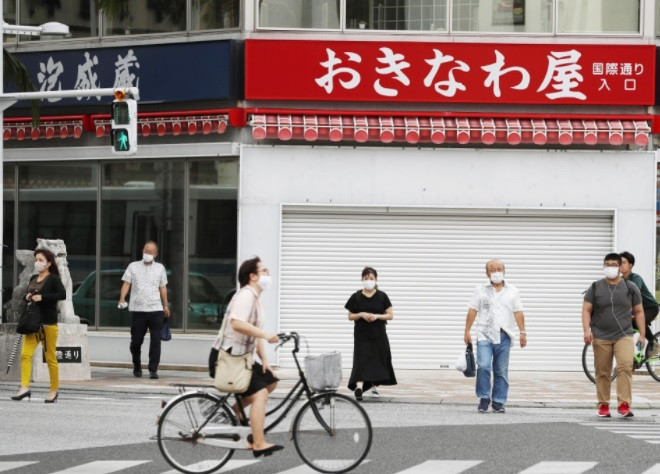 Người dân đi lại trên một con phố chính ở Naha, tỉnh Okinawa vào ngày 21/5/2021. (Nguồn: english.kyodonews.net) Dịch COVID-19: Tỉnh Okinawa của Nhật Bản đóng cửa nhiều trường học ảnh 1