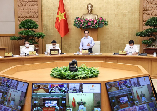 Sáng 30/7, tại Trụ sở Chính phủ, Thủ tướng Phạm Minh Chính chủ trì Hội nghị trực tuyến Chính phủ với các địa phương về tình hình phòng, chống dịch và triển khai thực hiện Nghị quyết của Quốc hội về việc thực hiện các giải pháp cấp bách phòng, chống dịch COVID-19 đã được thông qua tại Kỳ họp thứ hhất, Quốc hội khóa XV. (Ảnh: Dương Giang/TTXVN) 10 sự kiện tiêu biểu của Quốc hội Việt Nam trong năm 2021 ảnh 6