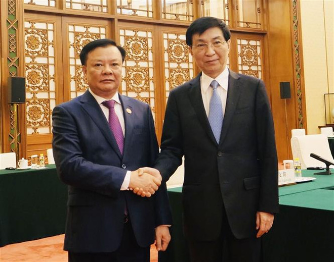 Bí thư Thành ủy Hà Nội Đinh Tiến Dũng và Chủ tịch Chính hiệp Toàn quốc Trung Quốc Vương Hộ Ninh. (Ảnh: Mạnh Cường/TTXVN) Việt Nam-Trung Quốc hướng tới tăng cường hợp tác Chuyển đổi Xanh ảnh 1