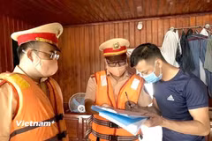 Lực lượng Cảnh sát giao thông đường thủy hướng dẫn các chủ phương tiện ký cam kết chấp hành nghiêm Luật Giao thông đường thủy. (Ảnh: Nguyễn Thảo/Vietnam+)