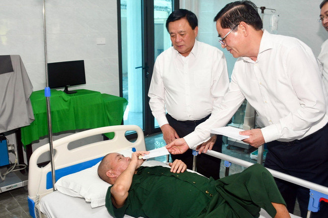 Giám đốc Học viện Chính trị Quốc gia Hồ Chí Minh Nguyễn Xuân Thắng và Bí thư Tỉnh ủy Bà Rịa-Vũng Tàu Phạm Viết Thanh tặng quà cho thương binh tại Trung tâm. (Ảnh: Đoàn Mạnh Dương/TTXVN) ong nguyen_xuan_thang_tham_tang_qua_thuong_benh_binh.jpg