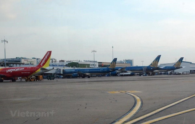 Máy bay của các hãng hàng không Vietnam Airlines và Vietjet. (Ảnh: Việt Hùng/Vietnam+) Tàu bay, xe khách, đường sắt hoạt động ra sao sau nới lỏng giãn cách? ảnh 1