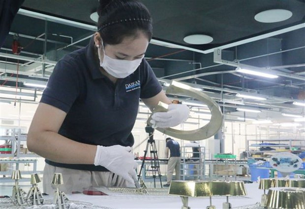 Công nhân làm việc trong doanh nghiệp 3 tại chỗ. (Ảnh: Công Phong/TTXVN) COVID-19: Khu vực xây dựng, dịch vụ-du lịch ảnh hưởng nặng nề nhất ảnh 1