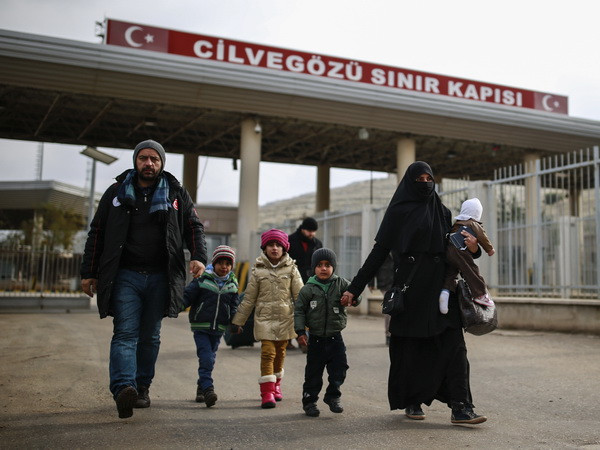 Người dân Syria băng qua cửa khẩu Cilvegozu để sang Thổ Nhĩ Kỳ ngày 17/12. (Nguồn: AP/TTXVN) Thổ Nhĩ Kỳ phá hủy 52 mục tiêu, tiêu diệt 11 phiến quân IS tại Syria ảnh 1
