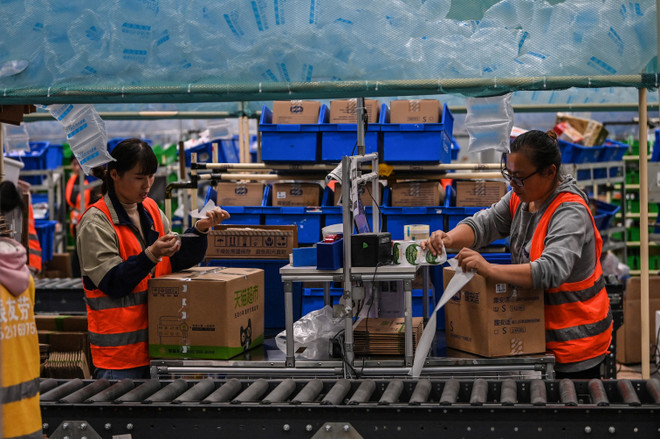Nhân viên làm việc tại một kho hàng của Alibaba tại tỉnh Giang Tô, Trung Quốc. (Ảnh: AFP/TTXVN) Thương mại điện tử và kinh tế số: Tăng trưởng chưa từng có tiền lệ ảnh 1