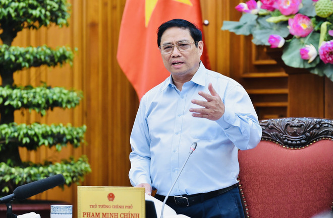 Thủ tướng Phạm Minh Chính chủ trì cuộc họp. (Ảnh: Dương Giang/TTXVN) Thủ tướng chủ trì họp điều hành kinh tế sau khi Fed tăng lãi suất ảnh 1