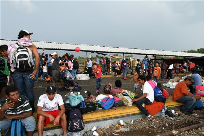 Người di cư Honduras tại khu vực Ciudad Tecun Uman ở biên giới Guatemala-Mexico, trong hành trình tới Mỹ ngày 21/10/2018. (Ảnh: AFP/TTXVN) Nhìn lại thế giới 2018: Thay đổi trong chính sách nhập cư của Mỹ ảnh 1