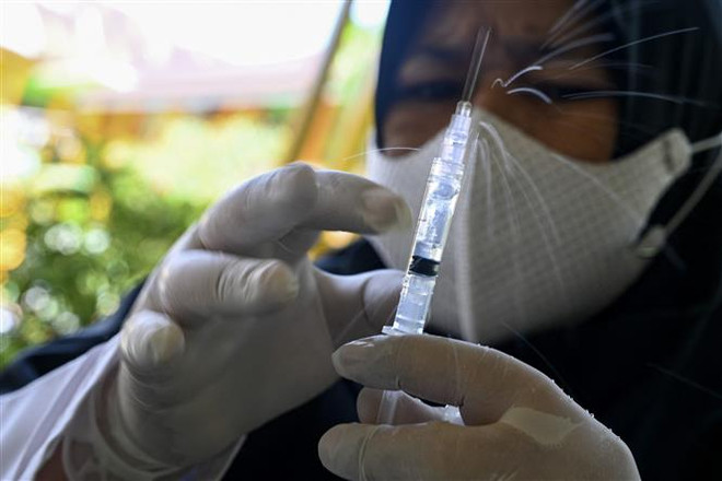 Nhân viên y tế chuẩn bị tiêm vaccine ngừa COVID-19 cho học sinh một trường tiểu học ở Banda Aceh, Indonesia, ngày 9/2/2022. (Ảnh: AFP/TTXVN) Indonesia thử nghiệm lâm sàng giai đoạn 3 vaccine ngừa COVID-19 nội ảnh 1