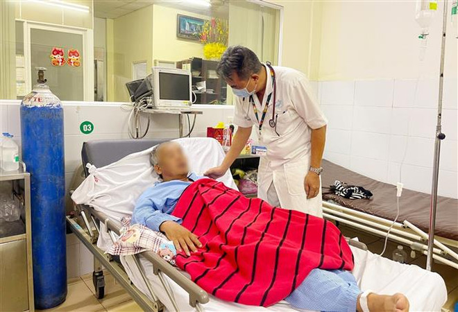 Bác sỹ Bệnh viện Quân y 175, Thành phố Hồ Chí Minh thăm khám cho các nạn nhân ngộ độc rượu sáng 15/7. (Ảnh: TTXVN phát) Cả ba nạn nhân vụ ngộ độc rượu ở Bình Phước đã bắt đầu hồi phục ảnh 1