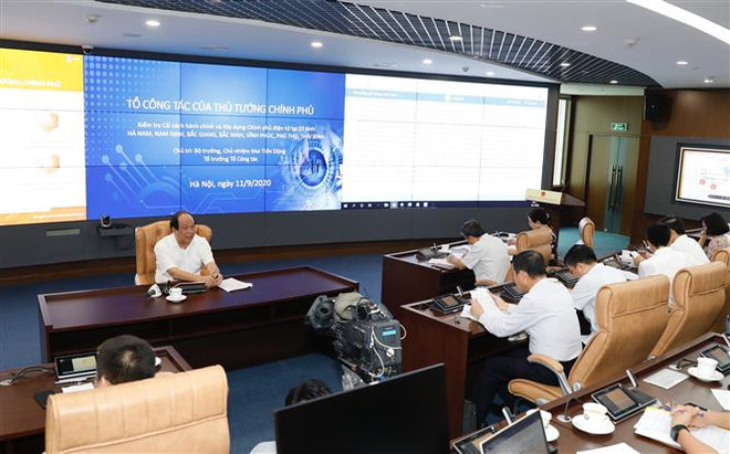 Bộ trưởng, Chủ nhiệm Văn phòng chính phủ, Tổ trưởng Tổ công tác của Thủ tướng Chính phủ Mai Tiến Dũng chủ trì buổi làm việc. (Ảnh: Dương Giang/TTXVN) Chính phủ yêu cầu các tỉnh đẩy nhanh tiến độ tích hợp dịch vụ công ảnh 1