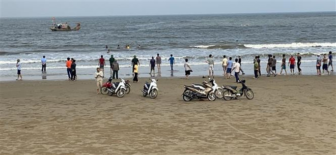 Người dân và lực lượng chức năng tìm kiếm 3 em học sinh còn mất tích. (Ảnh: Trịnh Duy Hưng/TTXVN) Thanh Hóa: Tìm thấy nạn nhân cuối cùng trong vụ 4 học sinh đuối nước ảnh 1