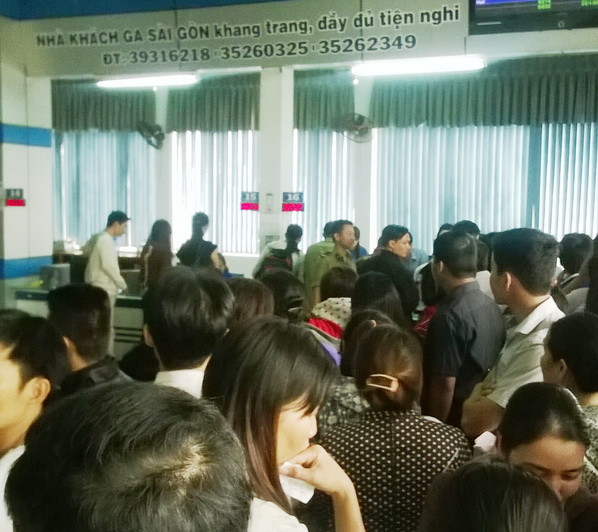 Hành khách chen chúc tập trung đổi vé (Ảnh: Trần Tình/Vietnam+) Hàng nghìn người chen chúc đổi vé tàu tại ga Sài Gòn ảnh 1